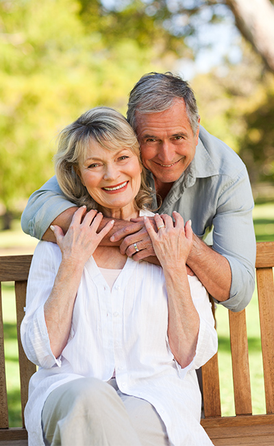 portrait of loving senior couple on park bench retirement future